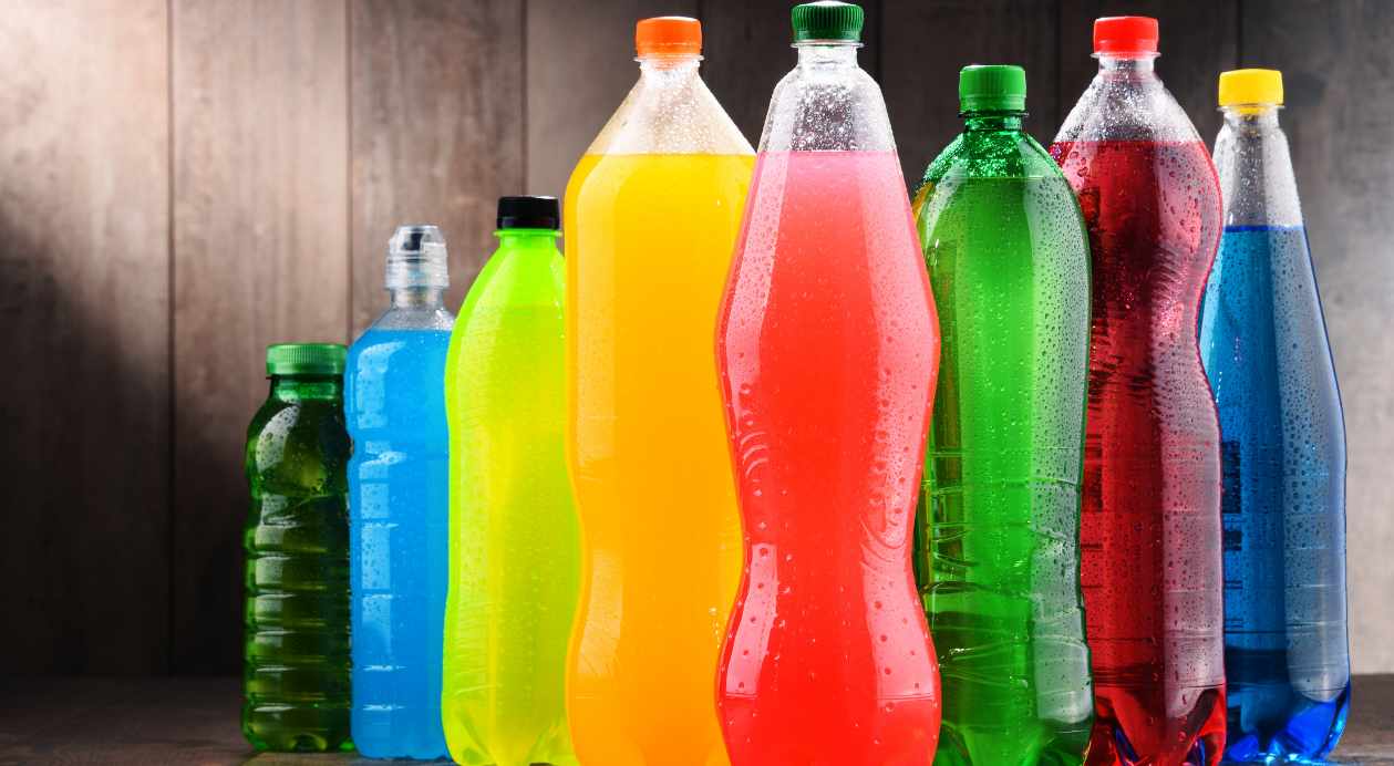 Vibrant PET bottles with green, red, blue, and other colored liquids.